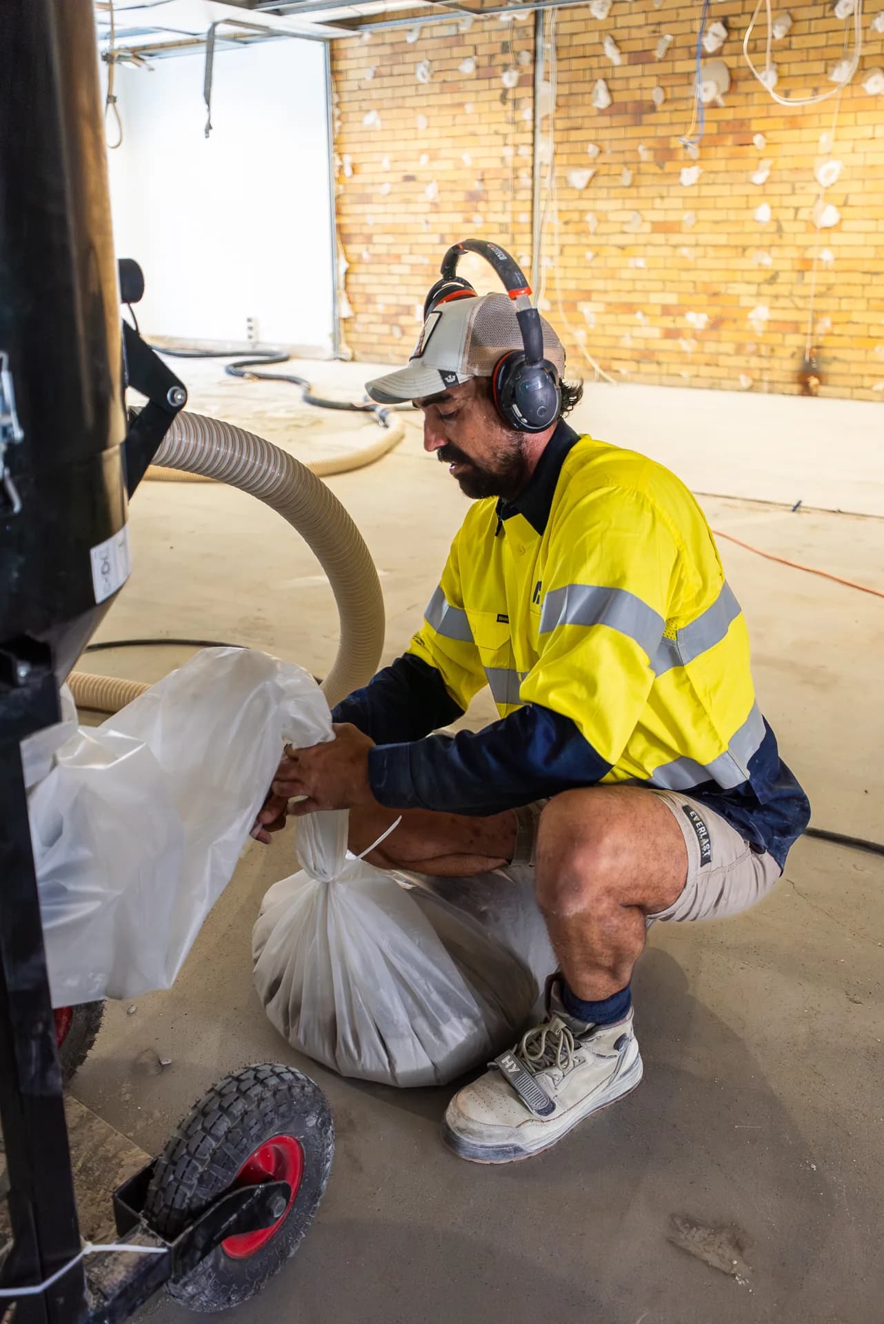 ICGC operator operating a Husqvarna concrete grinder on a commercial floor at James St Gold Coast